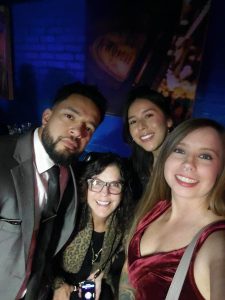 Group of young people dressed up fancy taking a selfie.